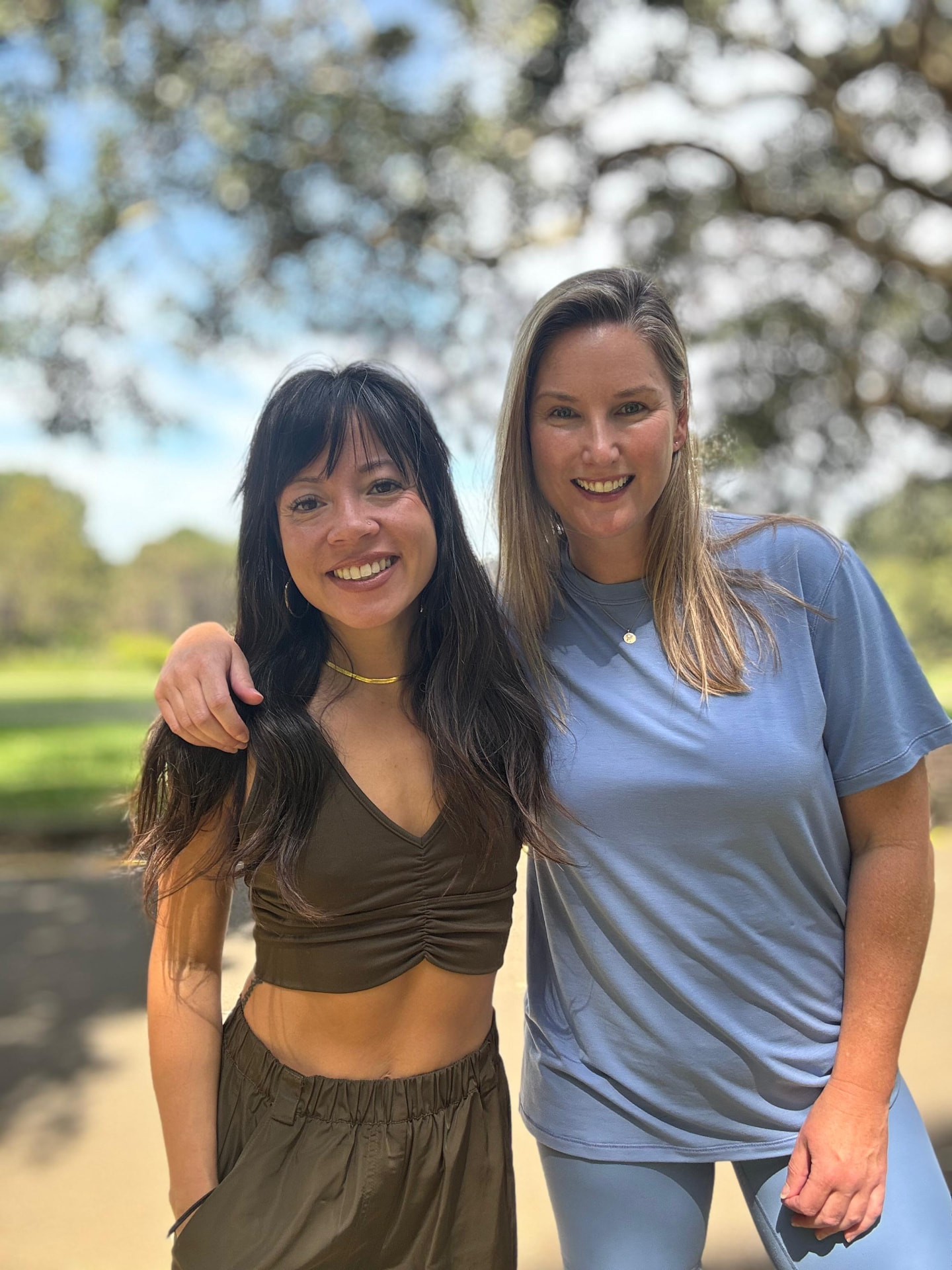 Tor and Coach Cris standing close together and smiling in a park